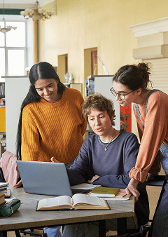 Group collaboration around a laptop.